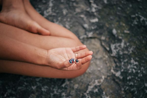 Close up of hands in a meditative mudra position.